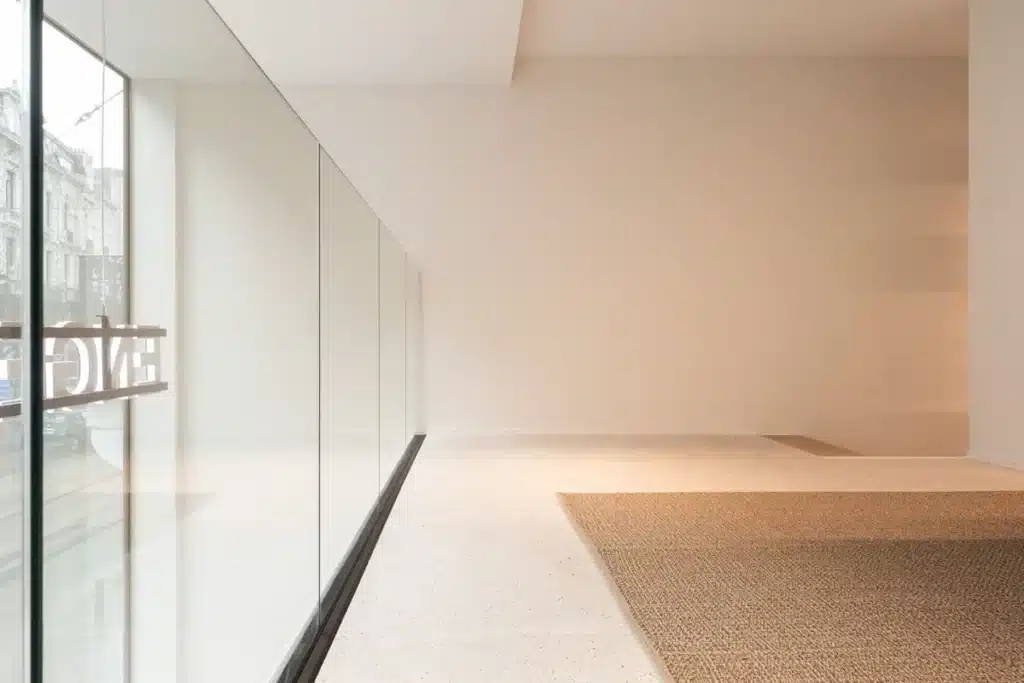 Glazen balustrade zonder bovenprofiel, strak ingewerkt in de vloer en perfect afgelijnd over de hele lengte.